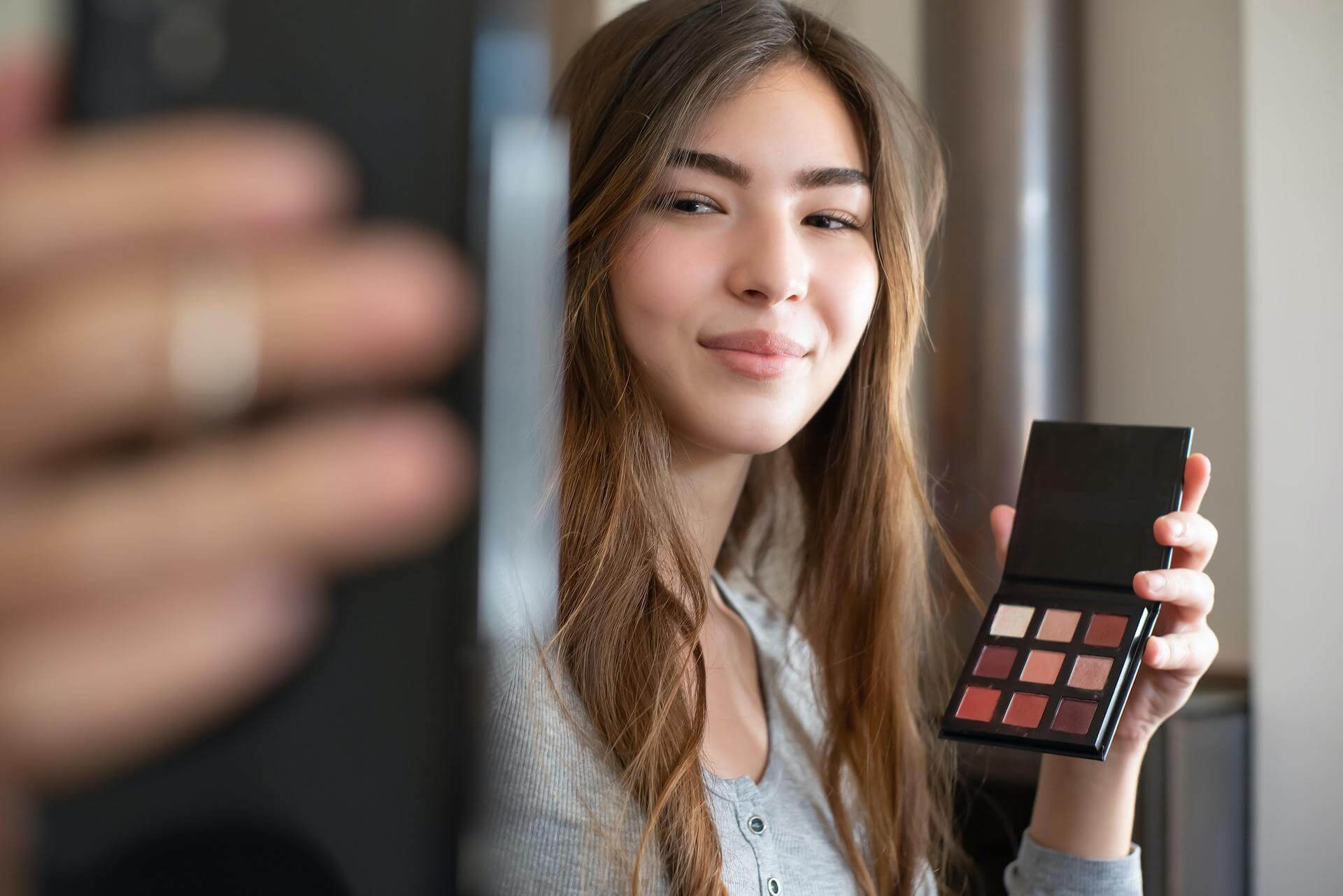 Femme présentant une palette de maquillage dans une session de live shopping Gleamer